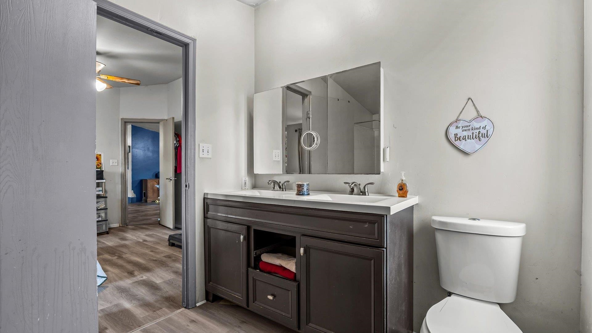 3216 E Road Clifton, CO 81520 - Photo 16 of 33 a bathroom with a toilet a sink and mirror