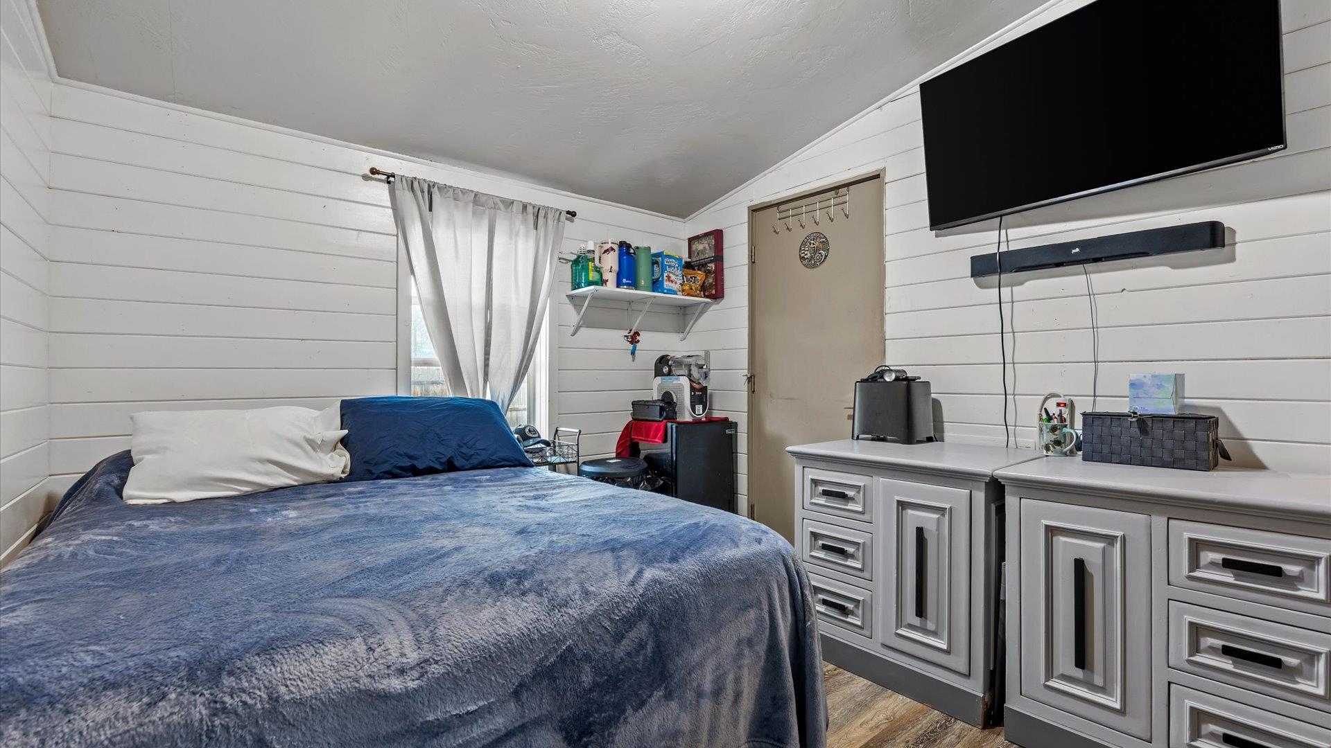 3216 E Road Clifton, CO 81520 - Photo 17 of 33 a bedroom with a bed and a flat screen tv