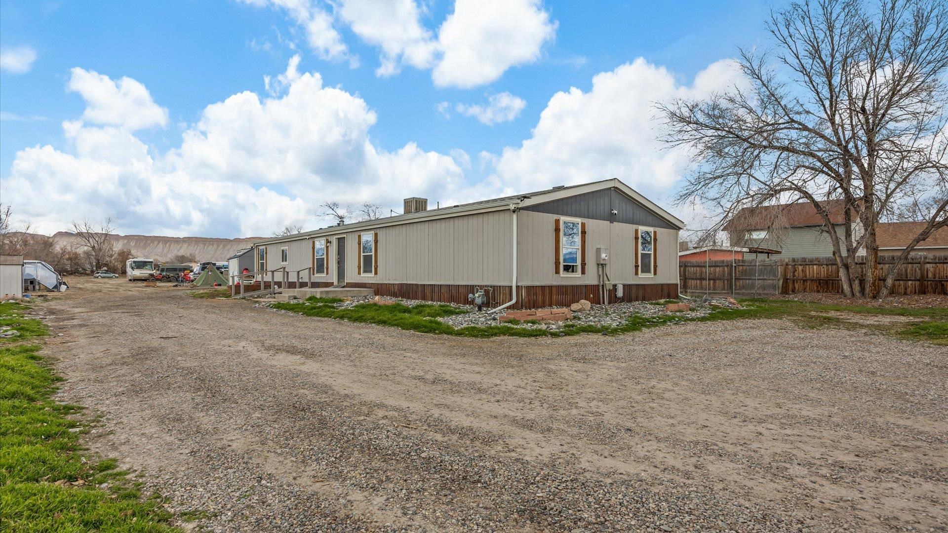 3216 E Road Clifton, CO 81520 - Photo 2 of 33 a view of a house with a big yard and large trees