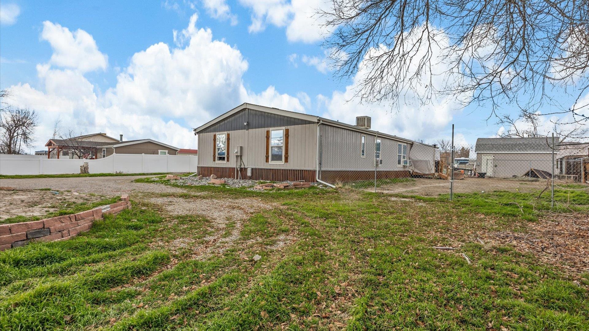 3216 E Road Clifton, CO 81520 - Photo 26 of 33 a white house that has a tree in front of it