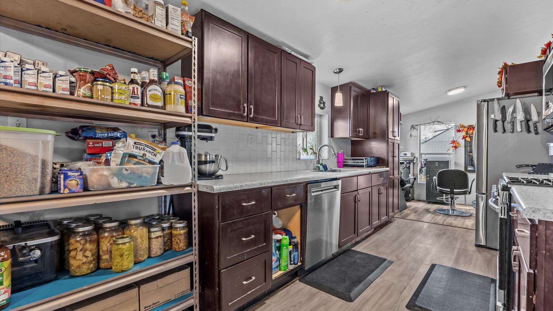 3216 E Road Clifton, CO 81520 - Photo 9 of 33 a kitchen with lots of clutter and cabinets