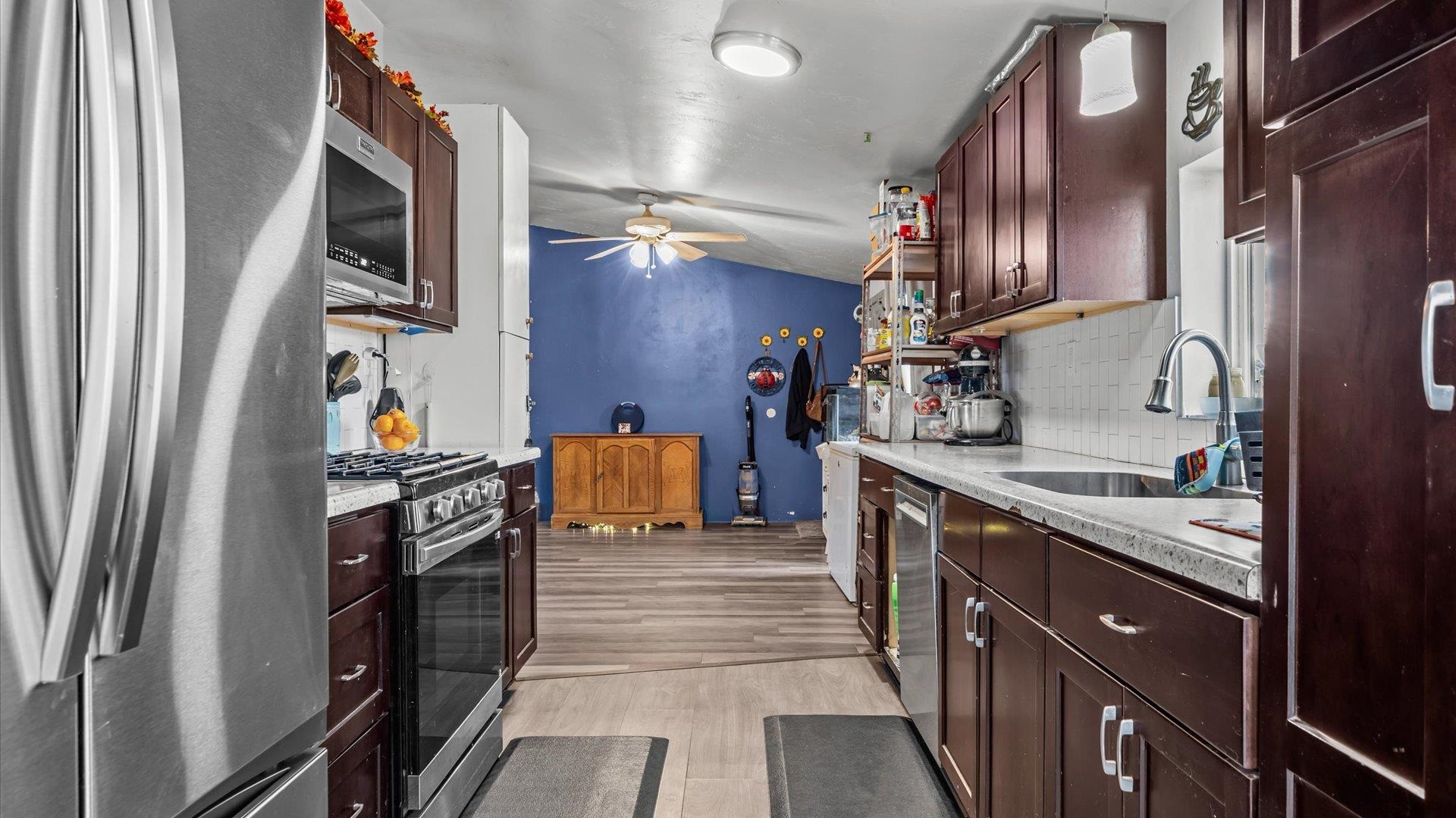 3216 E Road Clifton, CO 81520 - Photo 10 of 33 a kitchen with stainless steel appliances granite countertop a refrigerator and a sink