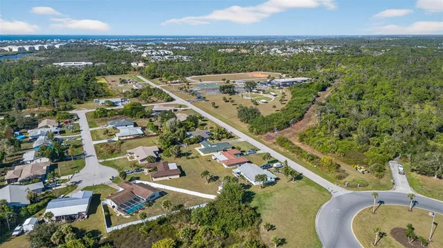 an aerial view of a residential houses with outdoor space and river view