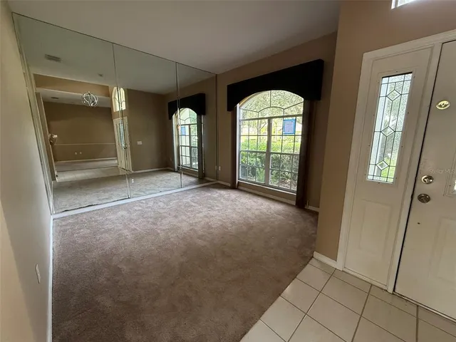 a view of an empty room with glass door