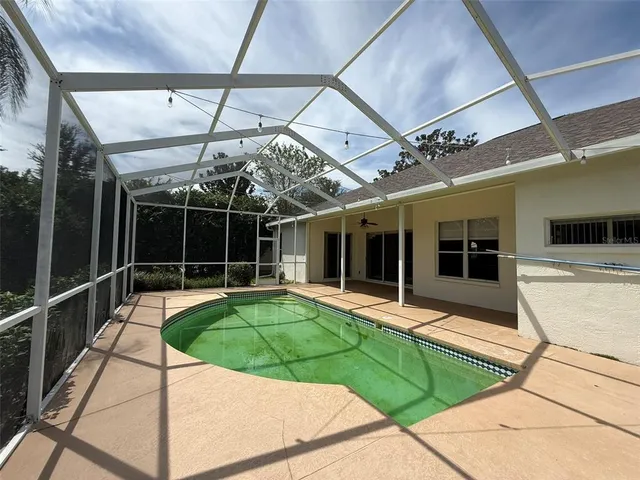 a view of a house with backyard and garden