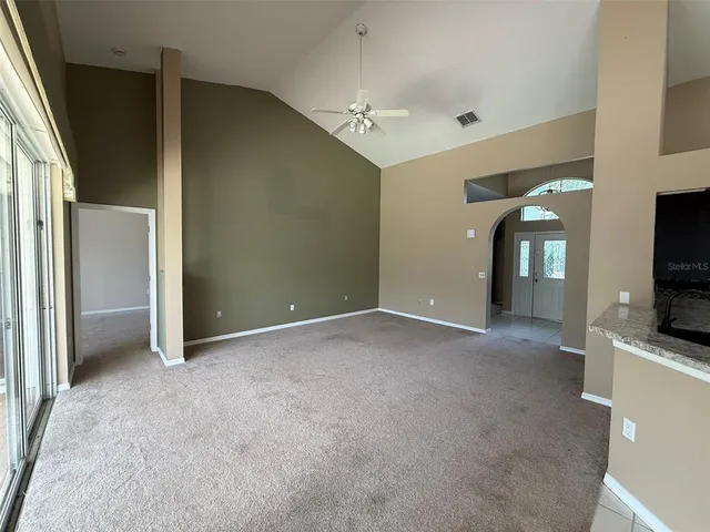 a view of a livingroom with an empty space and a fireplace
