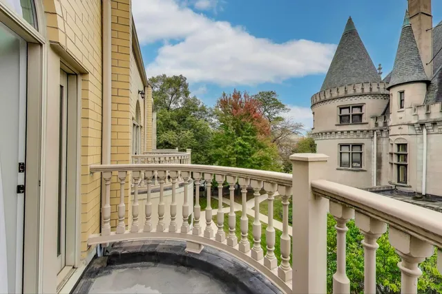 a view of a balcony with wooden floor and fence