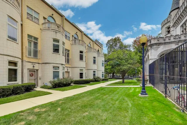 a front view of a building with a yard