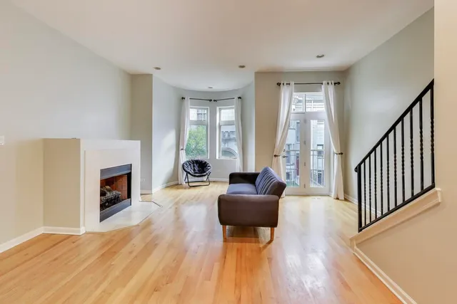 a living room with a couch and a ceiling fan
