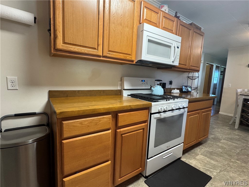 10180 Partridge Road Colden, NY 14080 - Photo 11 of 34 Warm oak cabinetry pairs with durable laminate countertops in this functional kitchen.