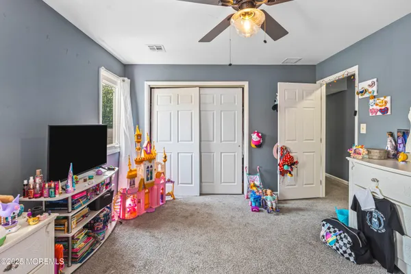 a children room with toys and a flat screen tv