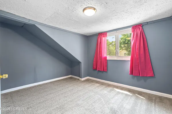 a view of room with window and flower