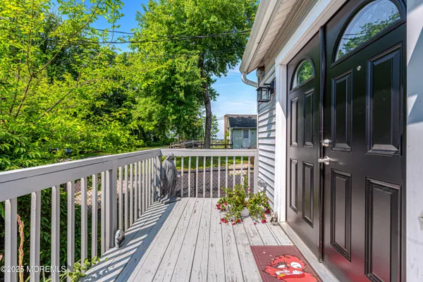 a view of a balcony with wooden floor
