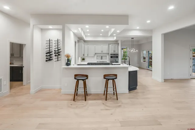 a kitchen with stainless steel appliances granite countertop a sink and a refrigerator