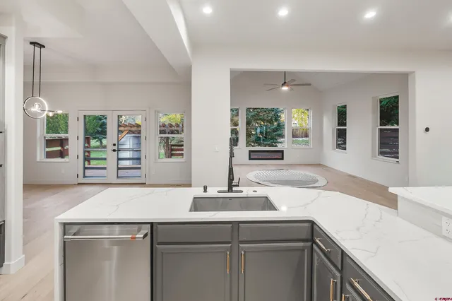 a kitchen with a sink and large window