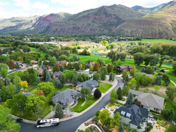 a large kitchen with stainless steel appliances a sink and a refrigerator