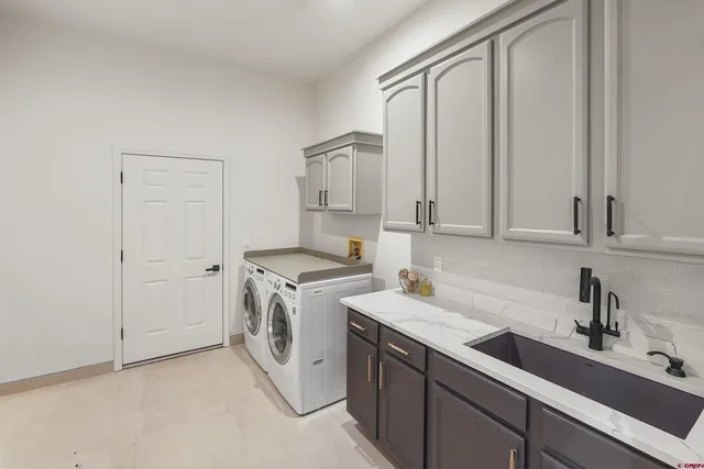 a utility room with cabinets washer and dryer