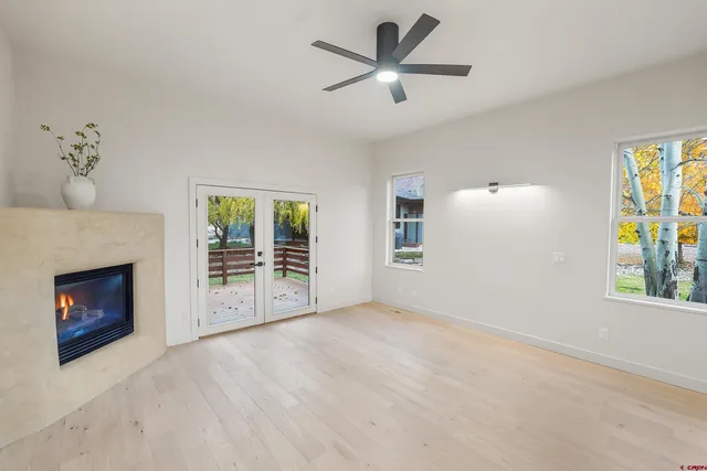 a view of an empty room with a fireplace and a window