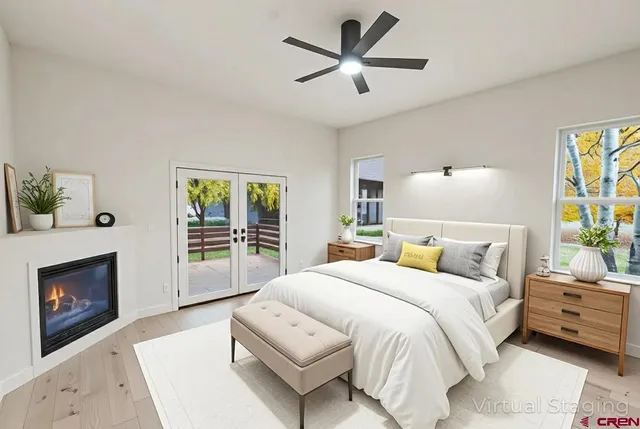 a bedroom with a large bed and a fireplace