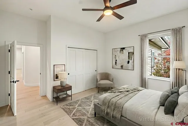 a bedroom with a bed and painting on the wall