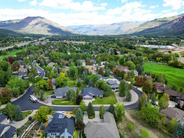 a kitchen with stainless steel appliances granite countertop a sink and a refrigerator