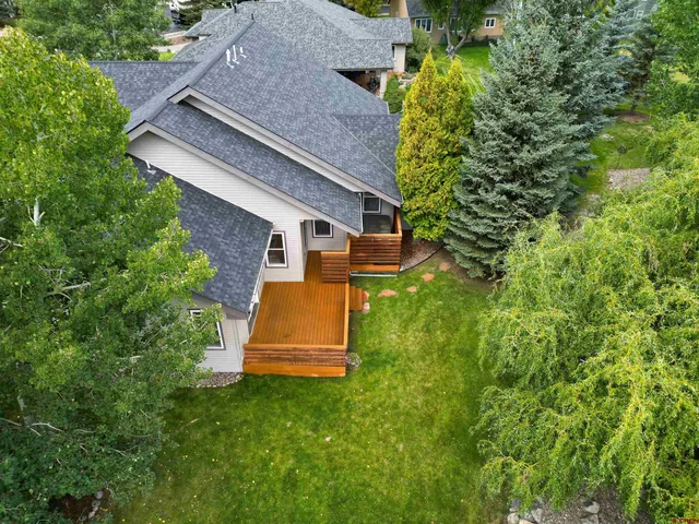 an aerial view of a house with a yard