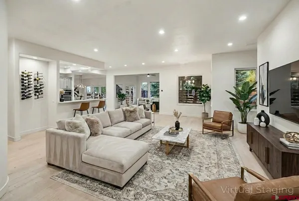 an empty room with wooden floor and stainless steel appliances