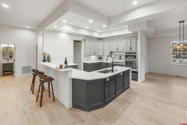 a bedroom with a bed and painting on the wall