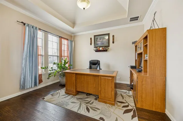 a view of a workspace with furniture and a window