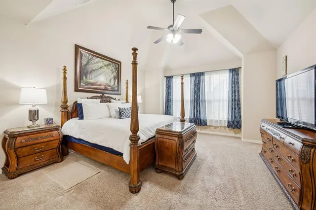 a bed room with a bed and a television