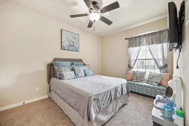 a bedroom with a bed chandelier and a window