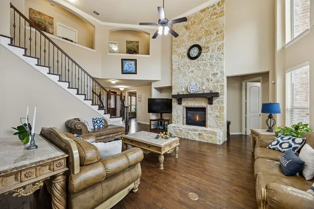a living room with furniture fireplace and wooden floor