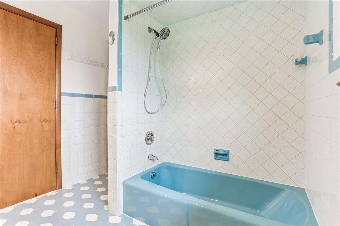 3659 Ironstone Road Bethlehem, PA 18020 - Photo 30 of 52 A classic blue bathtub and tiled shower stall highlight this well-maintained bathroom.