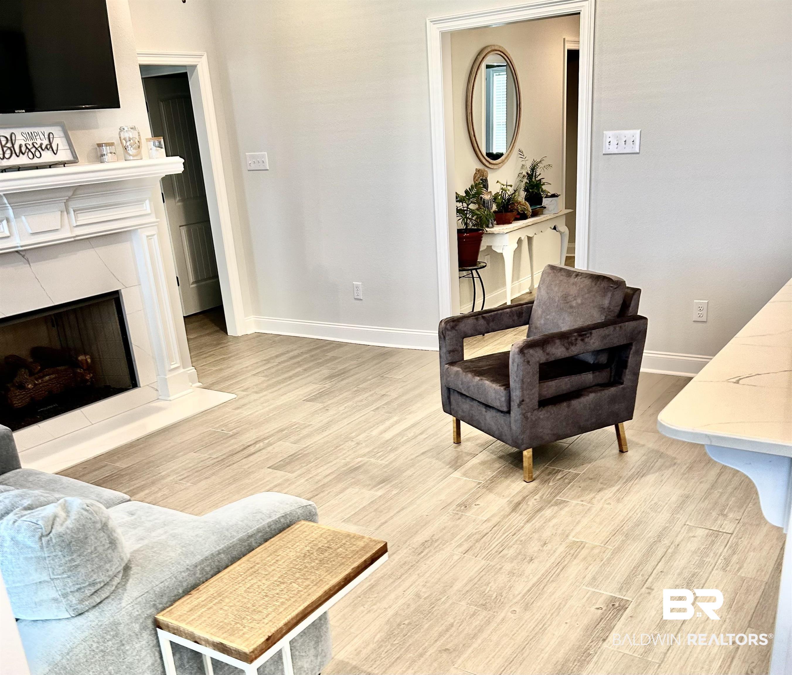 1398 Aldon Street Foley, AL 36535 - Photo 9 of 32 Living room with a fireplace and light tile wood-style floors