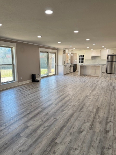 3500 Doris Street Bay City, TX 77414 - Photo 14 of 22 an empty room with wooden floor and windows