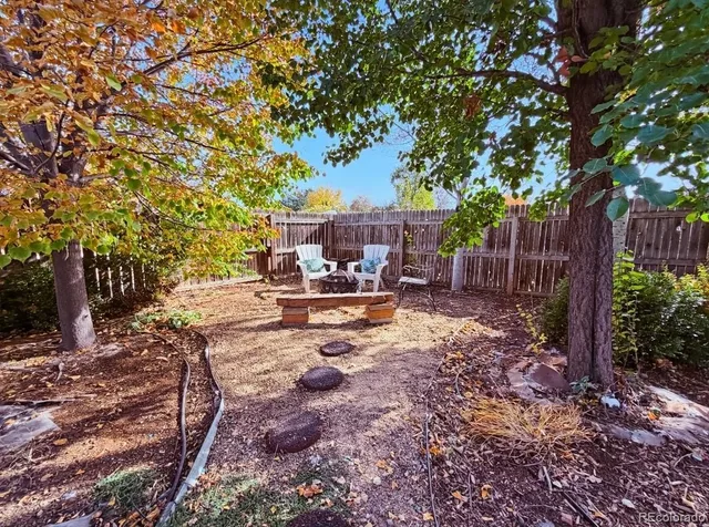 a view of a yard with swimming pool and sitting area