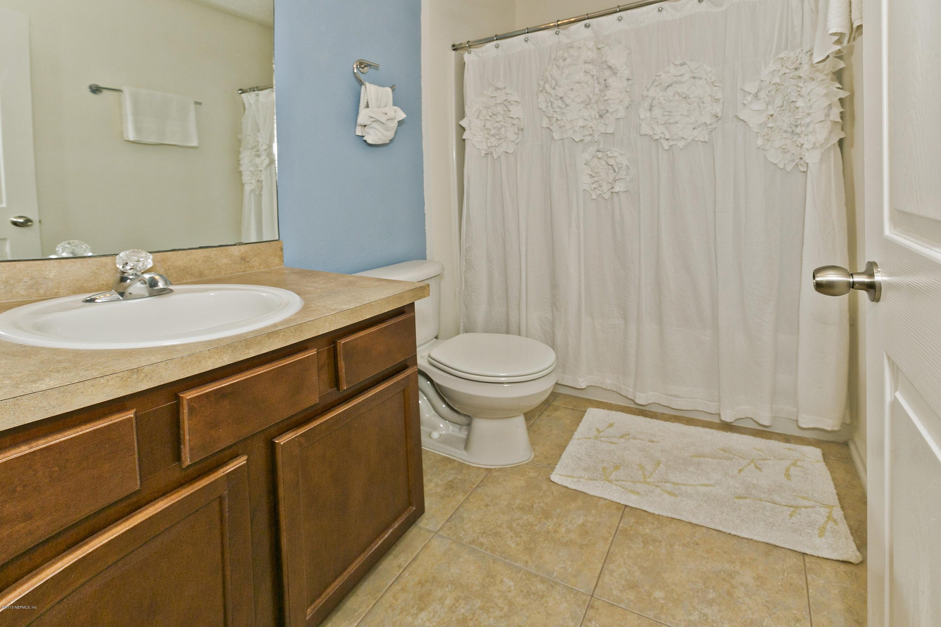 76 North Twin Maple Road St. Augustine, FL 32084 - Photo 13 of 21 a bathroom with a sink toilet and shower