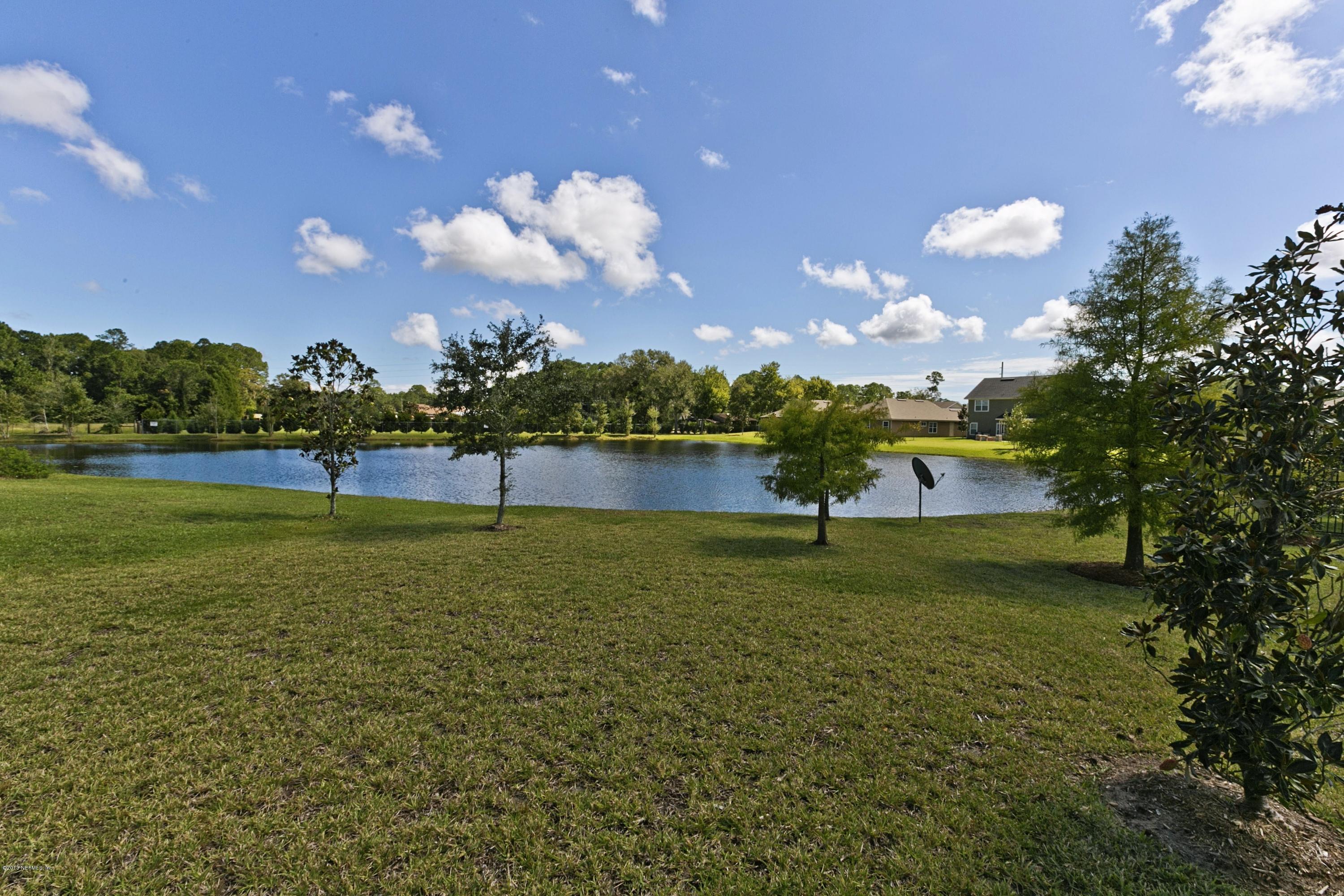 76 North Twin Maple Road St. Augustine, FL 32084 - Photo 18 of 21 a view of a golf course with a lake