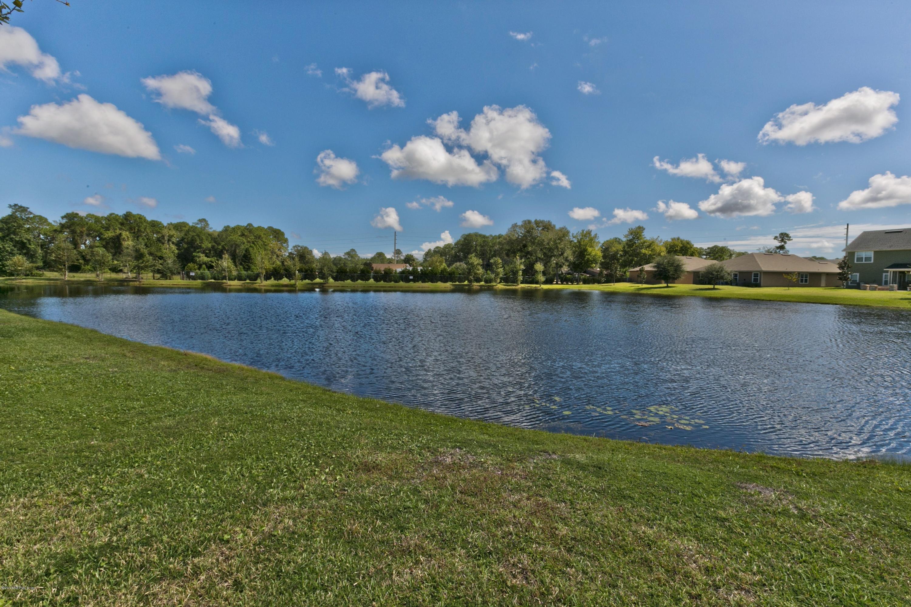 76 North Twin Maple Road St. Augustine, FL 32084 - Photo 19 of 21 a view of a lake with houses in the back
