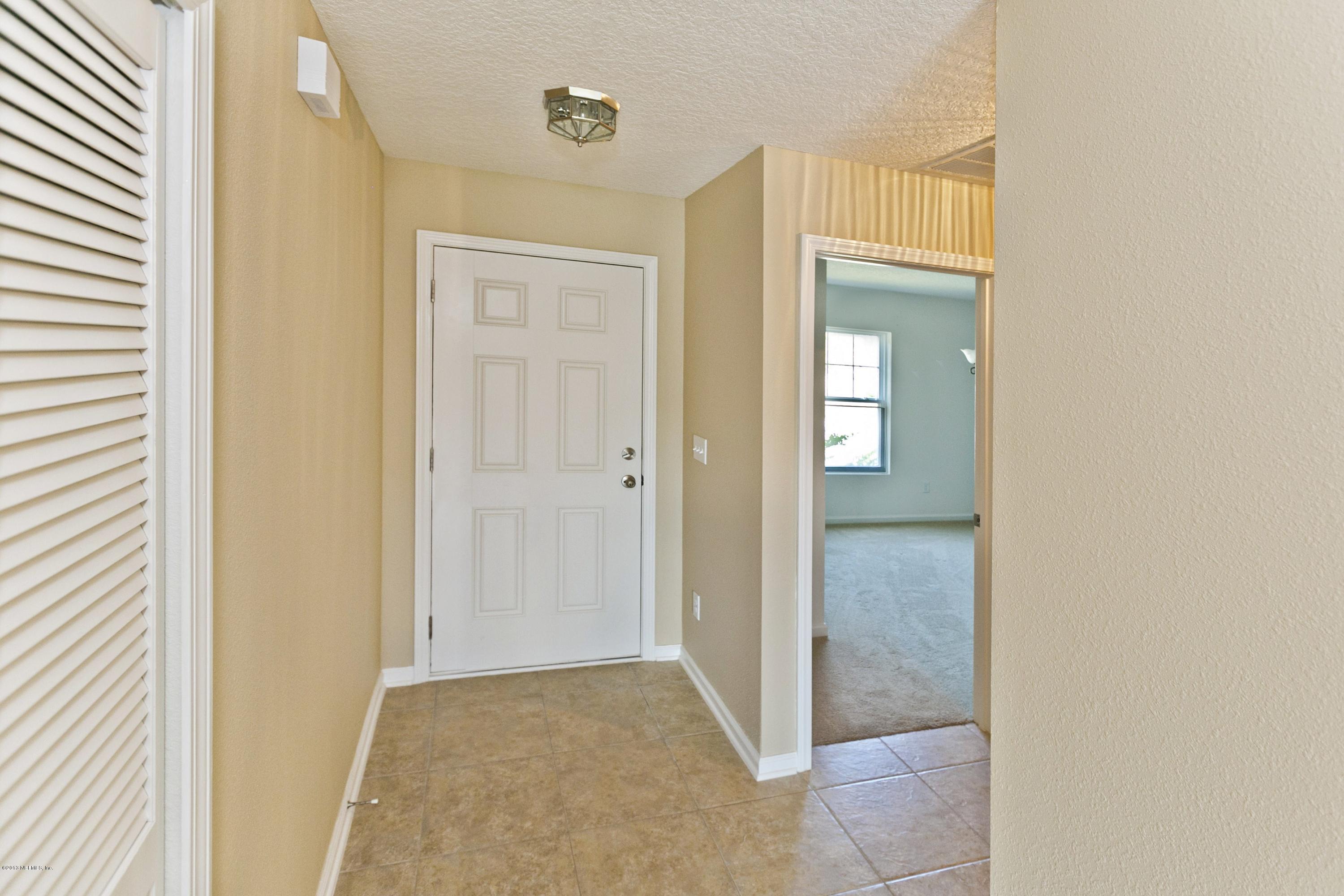 76 North Twin Maple Road St. Augustine, FL 32084 - Photo 2 of 21 a view of a hallway with wooden floor