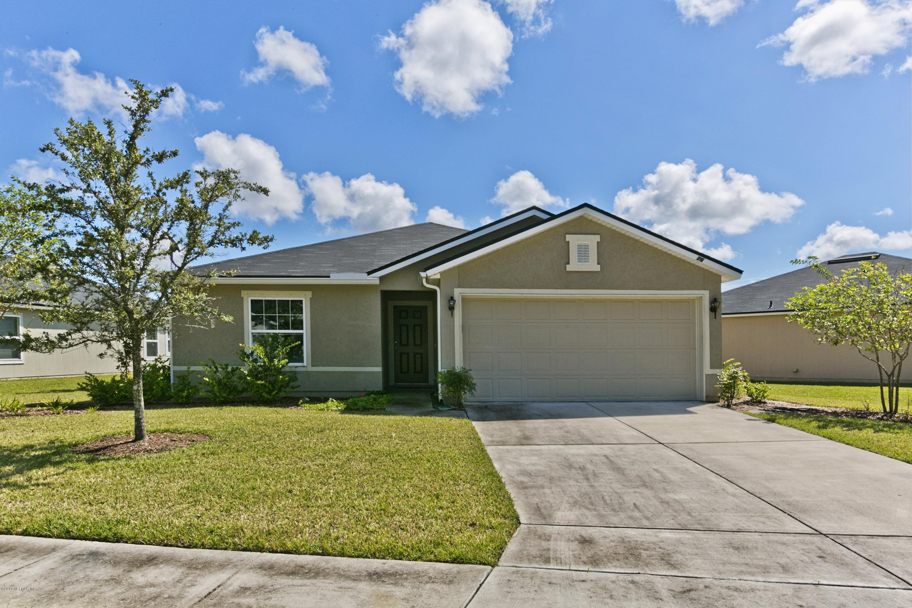 76 North Twin Maple Road St. Augustine, FL 32084 - Photo 21 of 21 a front view of a house with a yard and a garage