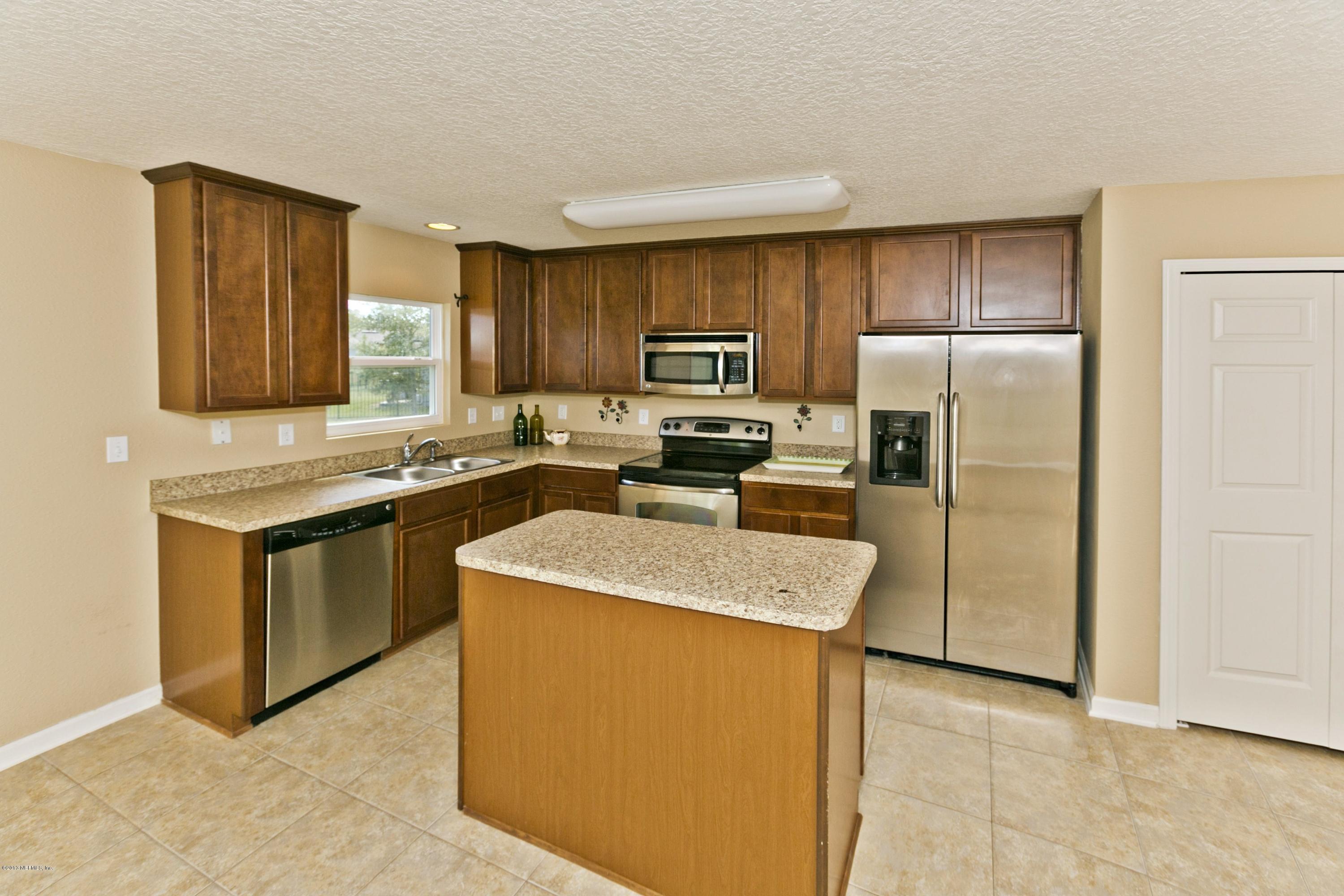 76 North Twin Maple Road St. Augustine, FL 32084 - Photo 4 of 21 a kitchen with stainless steel appliances granite countertop a refrigerator stove and a sink