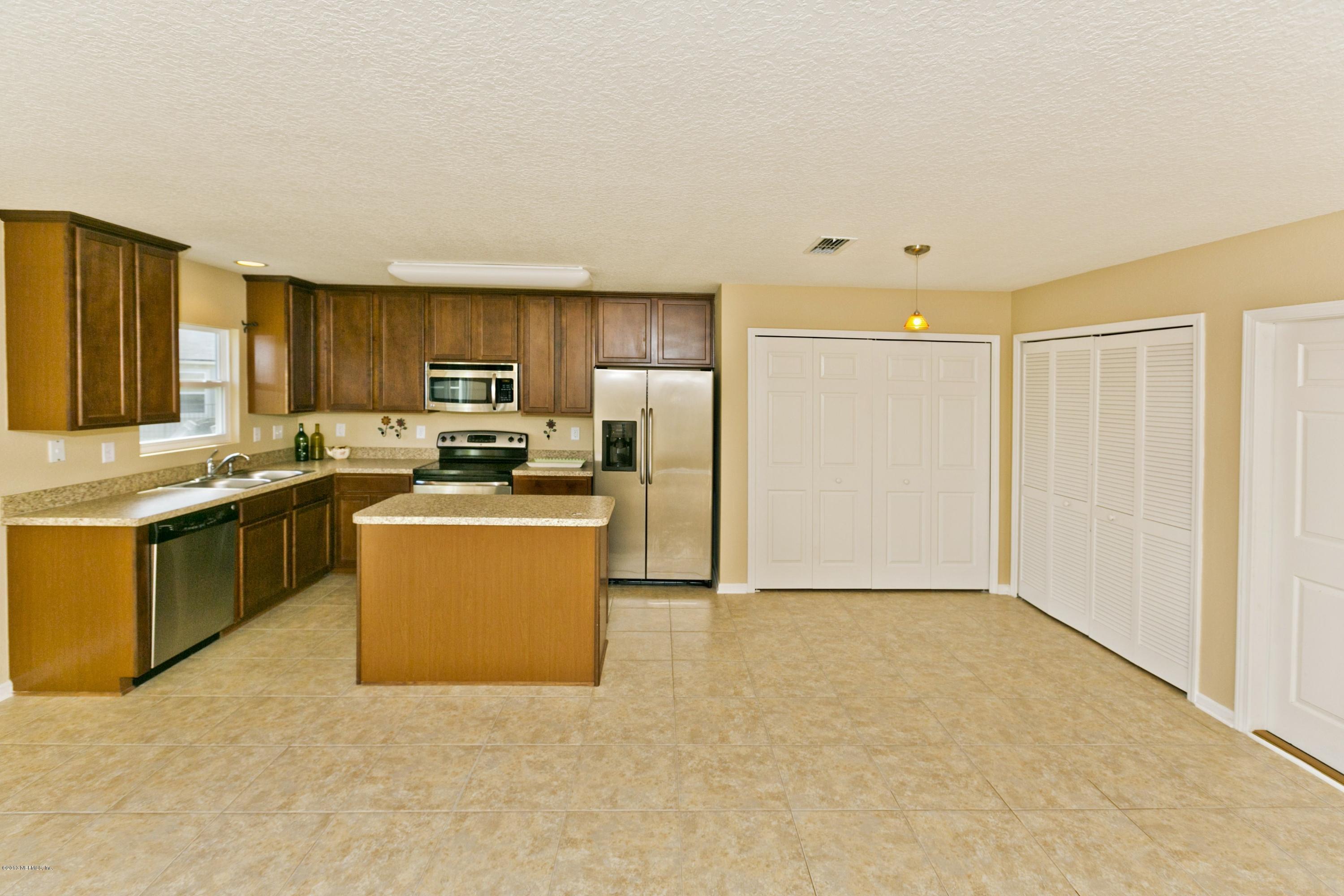 76 North Twin Maple Road St. Augustine, FL 32084 - Photo 6 of 21 a kitchen with granite countertop a refrigerator stove top oven and sink