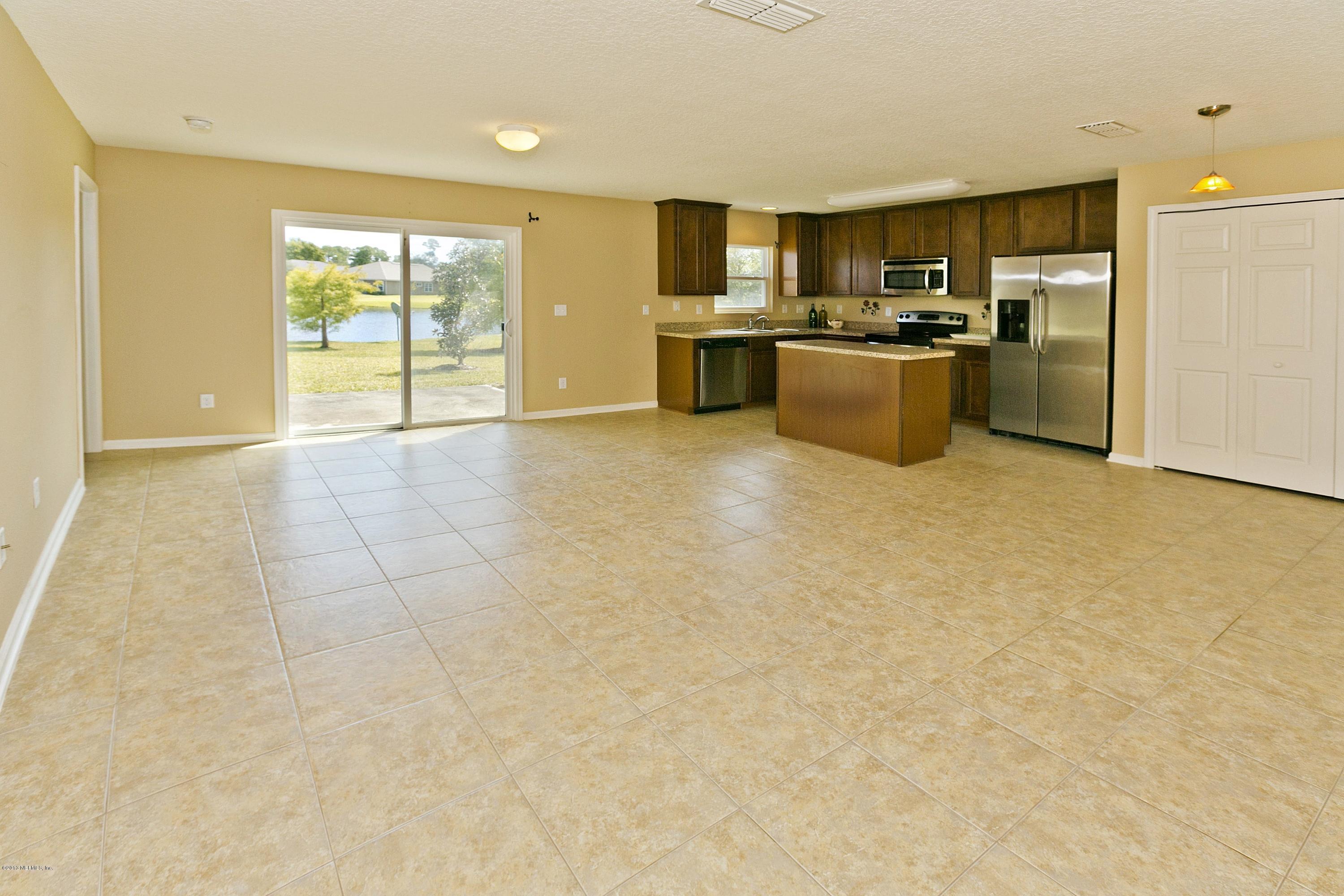 76 North Twin Maple Road St. Augustine, FL 32084 - Photo 7 of 21 a kitchen with stainless steel appliances a stove a refrigerator a sink a microwave a counter top space and cabinets