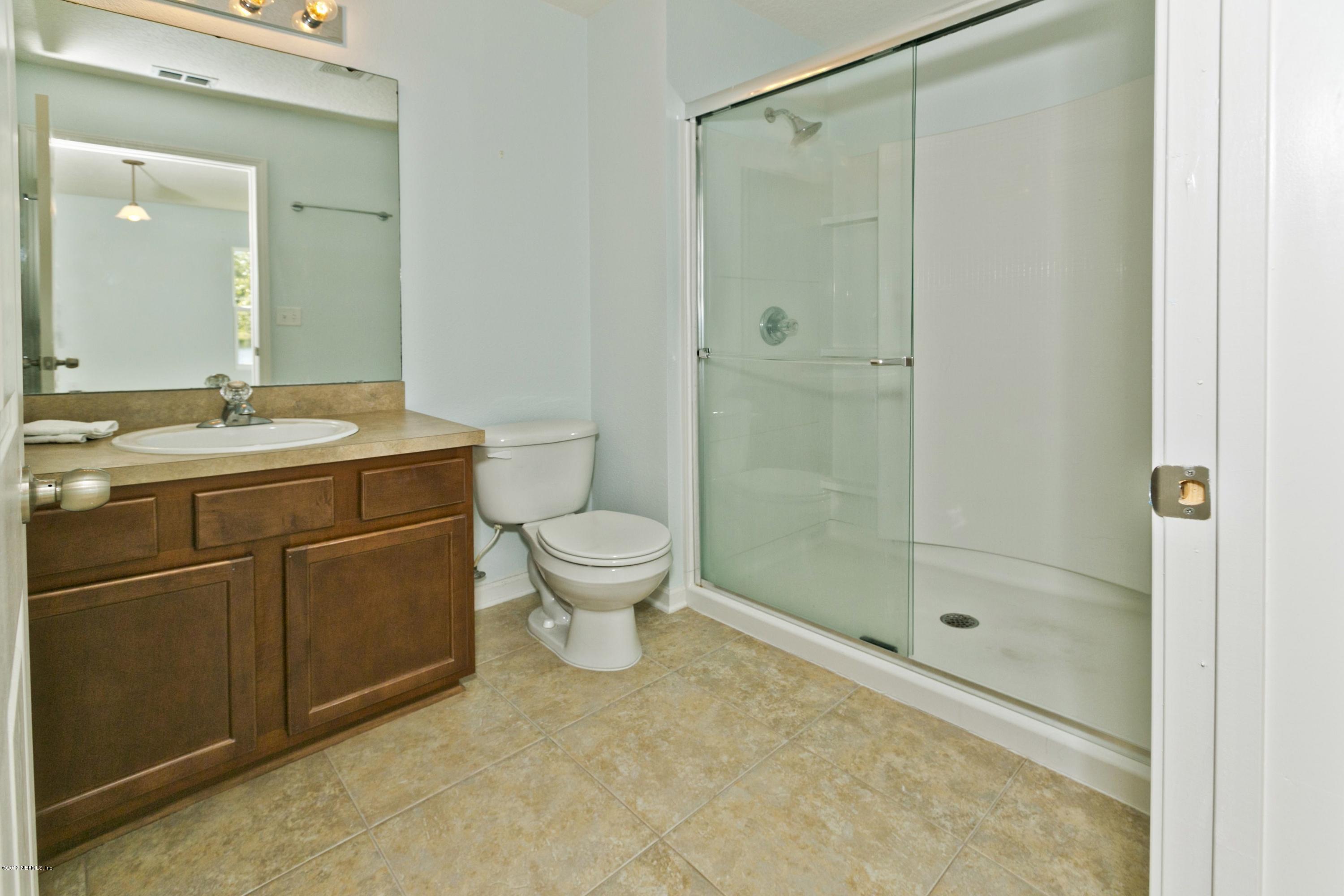 76 North Twin Maple Road St. Augustine, FL 32084 - Photo 10 of 21 a bathroom with a granite countertop sink toilet and shower