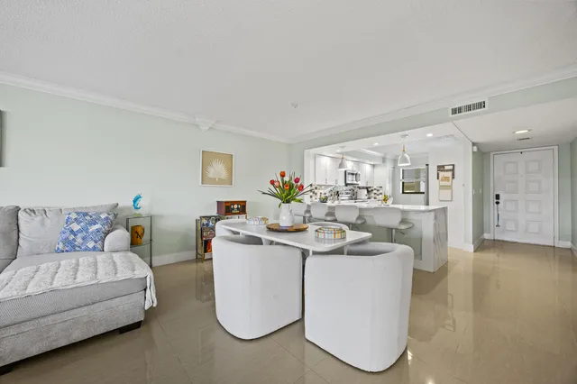 a living room with furniture and view of kitchen