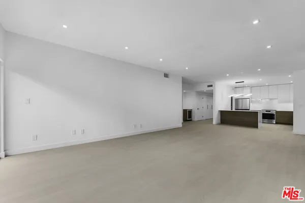 a view of kitchen and refrigerator