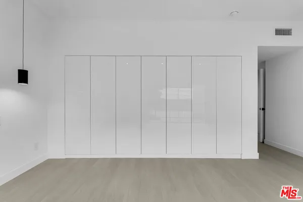 a view of an empty room with a ceiling fan