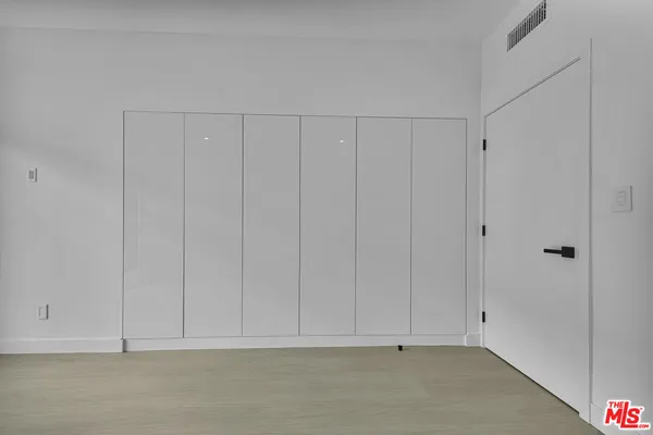 a bathroom with a sink a toilet a mirror a bathtub and shower