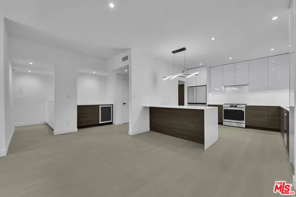 a view of kitchen with refrigerator and microwave